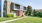 a house with a lawn and trees