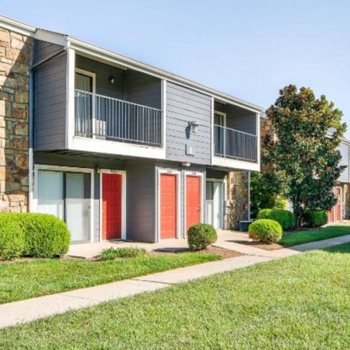 a house with a lawn and trees